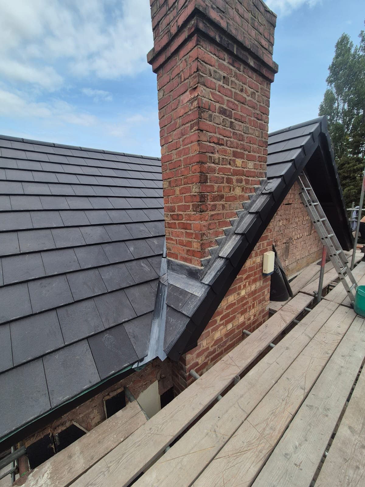 Close-up of new lead flashing dressed around the chimney stack