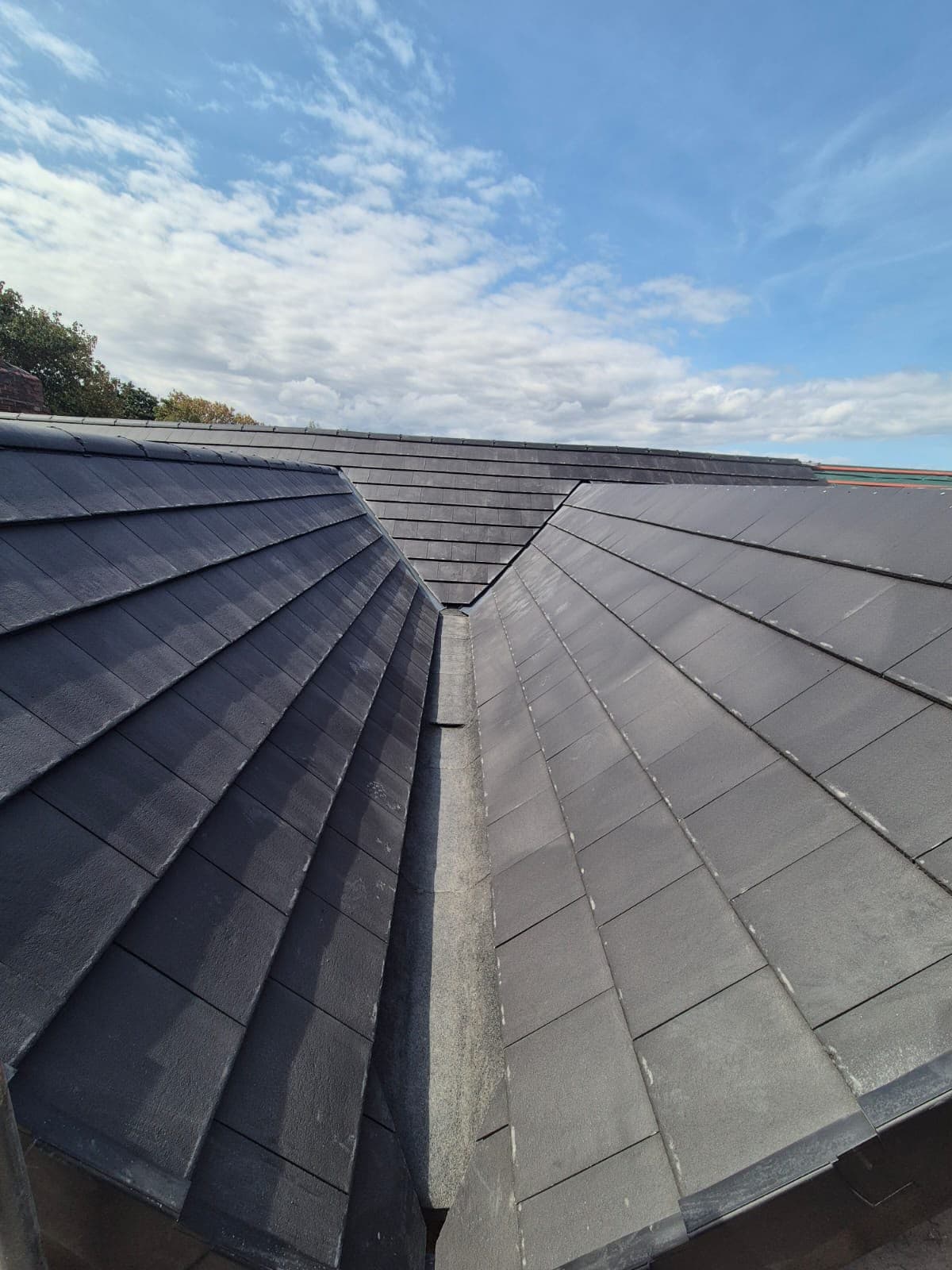 Close view of a hip and valley junction on the new roof